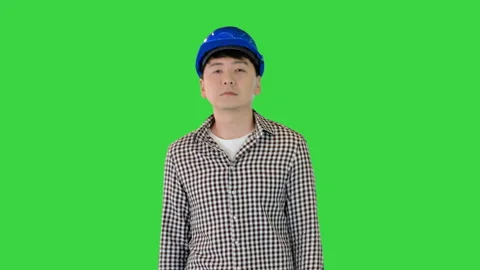 Construction man in a hardhat walking on a Green Screen, Chroma Key. Stock Footage 157020379
