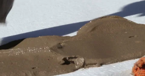 Construction. Man inflicts mortar on styrofoam. Close-up. Stock Footage 53857499