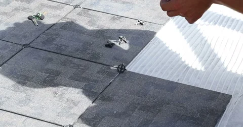 Construction. Man puts tile. Close up. Stockbeeldmateriaal 53857666