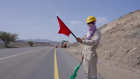 Construction man in the site regulates traffic in Oman Stock Footage 325430159