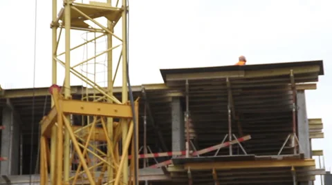Construction. Man walks on the top of building. Crane. Stock Footage 53824839