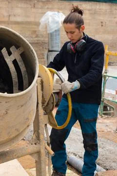 Construction man worker making concrete in the cement mixer at construction s Foto stock