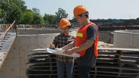 Construction manager and engineer discussing on construction site. Stock Footage 118348564