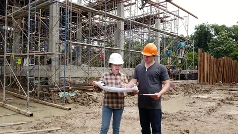 Construction manager and engineer discussing and checking plans. Stock Footage 119530521