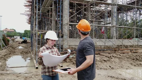Construction manager and engineer discussing and checking plans. Stock Footage 120251541