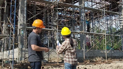 Construction manager and engineer discussing and checking plans Stock Footage 120787759