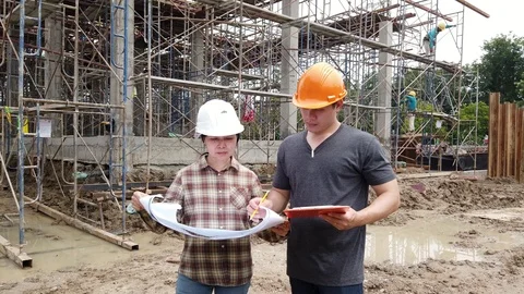 Construction manager and engineer discussing and checking plans Stock Footage 121044477