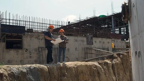 Construction manager and engineer discussing plans on construction site. Stock Footage 135454435