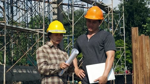 Construction manager and engineer discussing and checking plans. Stock Footage 136900422