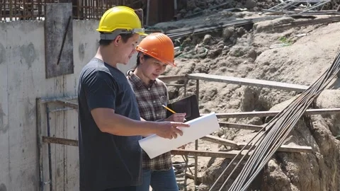 Construction manager and engineer discussing and checking plans. Stock Footage 154508211