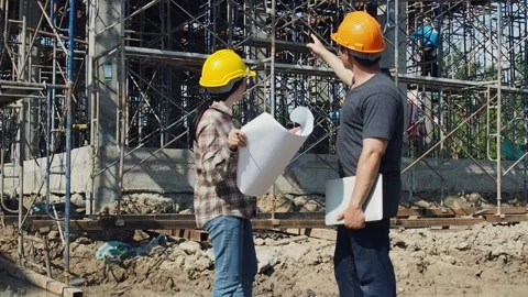 Construction manager and engineer discussing and checking plans. Stock Footage 155619069