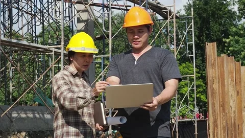 Construction manager and engineer discussing on construction site. Stock Footage 163829639
