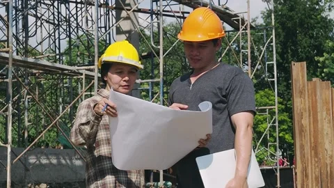 Construction manager and engineer discussing plans on construction site. Stock Footage 197066819