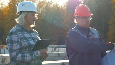 Construction manager and engineer discussing project with tablet Stock Footage 320462051