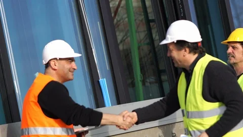 Construction manager and workers shaking hands on construction site Stock Footage 88623395