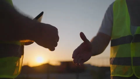 Construction manager and workers shaking hands on construction site. Builder man Stock Footage 156015379