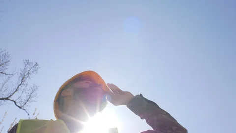 Construction manager in a helmet with a beard and mustache standing .blue sky Stock Footage 106019796