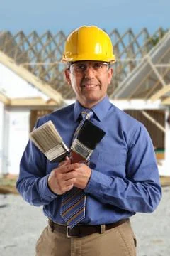 Construction manager holding paintbrushes Stock Photos