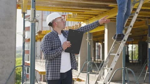 Construction manager inspecting building progress on site Stock Footage 343449467
