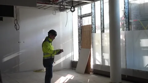 Construction manager inspecting building site using tablet device, supervisor Stock Footage 332584319