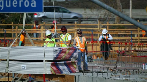 Construction manager instructs workers how to handle heavy load from the crane Stock Footage 34512200