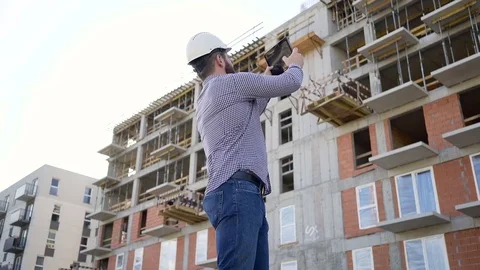 Construction manager make photo of construction by tablet. Slider shot right. 库存影片 70804493