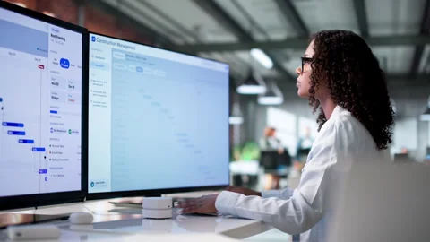 Construction Manager Reviews Project Schedule On Computer Stock Footage 339190534