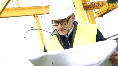 Construction manager on site reading blueprint Stock Footage 86616980