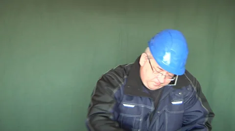 Construction manager using mobile device, cellphone, writing, on green screen. Video stock 32164058