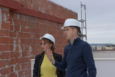 Construction managers discussing building plans on a new development site, .. Stock Photos