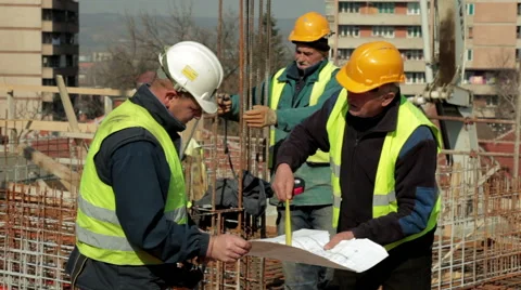 Construction managers with helmets watching project at construction site. Video stock 47296800