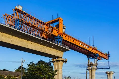 Construction of massive elevated railway viaduct using  gantry crane for gi.. Stock Photos