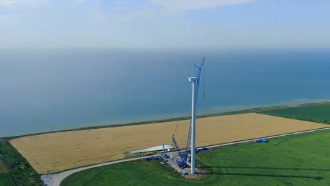 Construction of a massive wind turbine, lots of heavy machinery, aerial footage Stock Footage 138141849