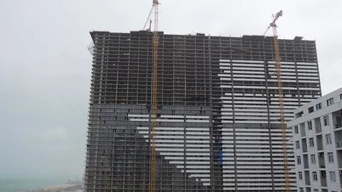 Construction material fall from roof of unfinished multistorey building in storm Stock Footage 118444748