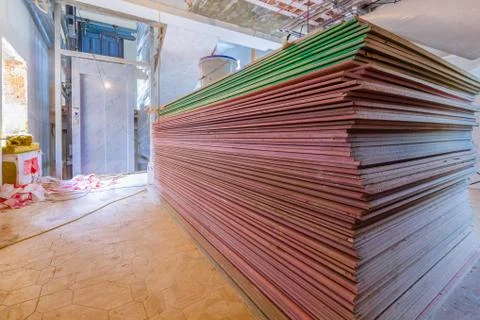Construction materials and sheets of plasterboard or drywall are prepared for Stock Photos