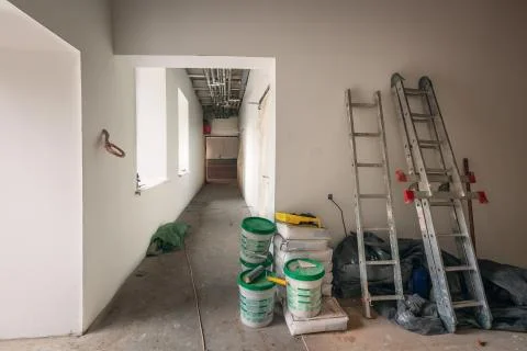 Construction materials, cans with paint , ladders and bags with cement Stock Photos