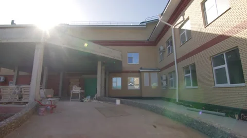 Construction materials lie near new brick building entrance Видео 335644140