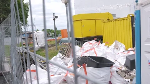 Construction Materials Stored Behind Fence at Building Site Stock Footage 337476707