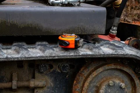 Construction measuring tape on a tractor track. Construction work Stock Photos