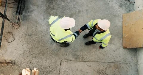 Construction, men and handshake with agreement on site for safety approval Stock Photos