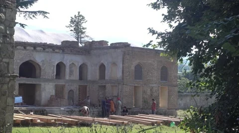 Construction men renovating a building in the old castle’s courtyard Stock Footage 66581049
