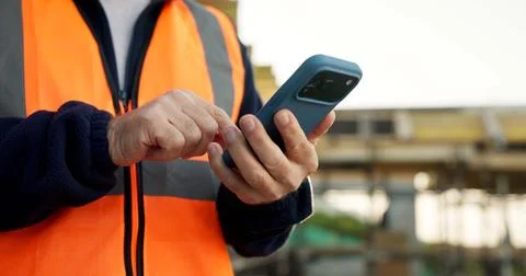 Construction, message or hands on worksite with phone, task instruction or Stock Photos