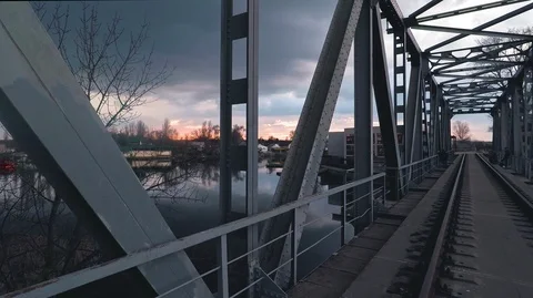 The construction of a metal bridge against the background of the  skys Stock Footage 125930806
