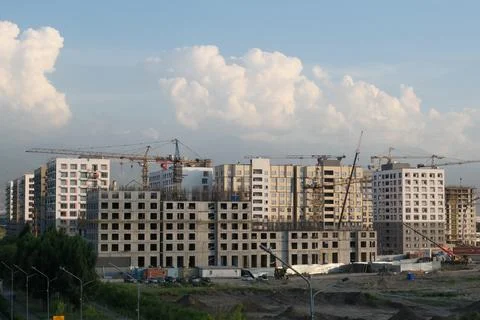 Construction of a microdistrict against the background of the sky and clouds Stock Photos