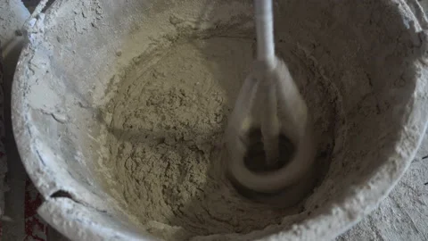 Construction mixer in a bucket with plaster Stock Footage 137918620