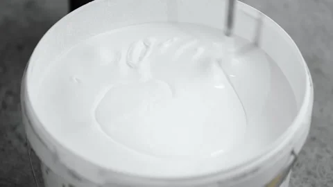 Construction mixer mixes white paint with bubbles Stock-Footage 226773067
