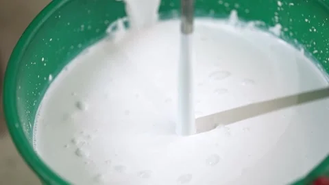 Construction mixer mixes white paint with bubbles Stock Footage 234652211