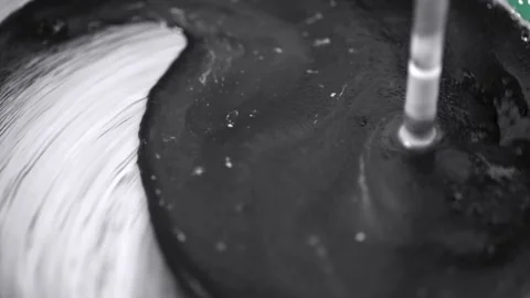 Construction mixer stirs black and white paint Stock Footage 221213173