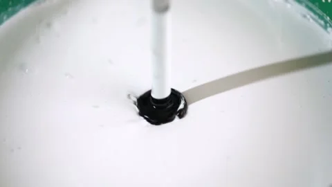 Construction mixer stirs black and white paint Stock Footage 223403356