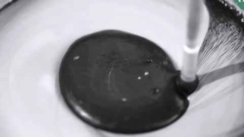 Construction mixer stirs black and white paint Stock Footage 229724962